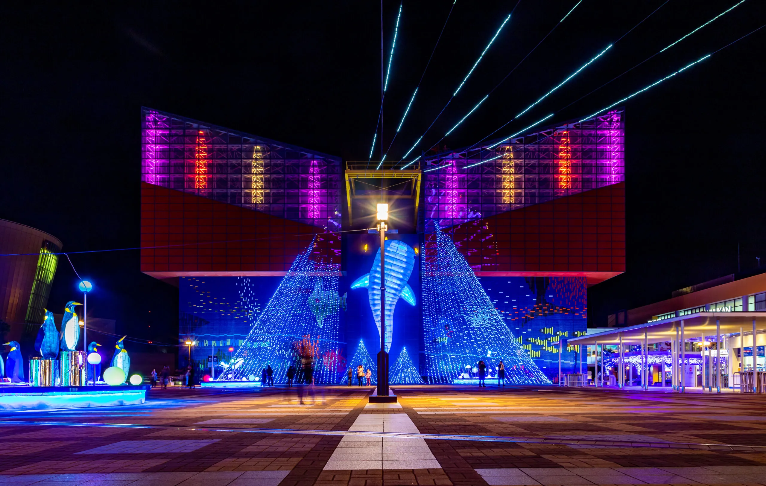 Kaiyukan lit up at night with a glowing whale shark display.