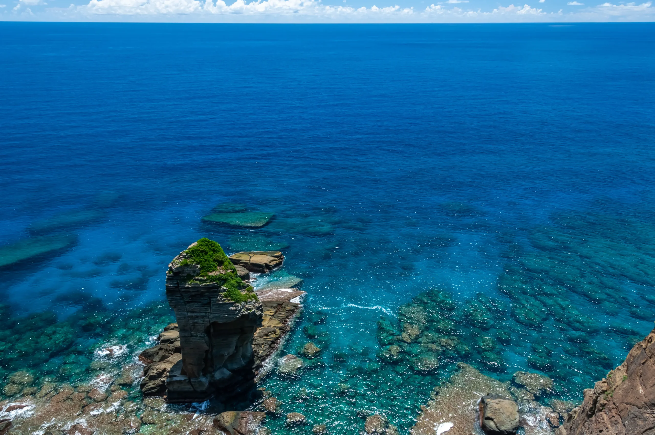 Dramatic coastal rock formation and clear blue ocean at Yonaguni Island, Japan’s westernmost island in Okinawa Prefecture