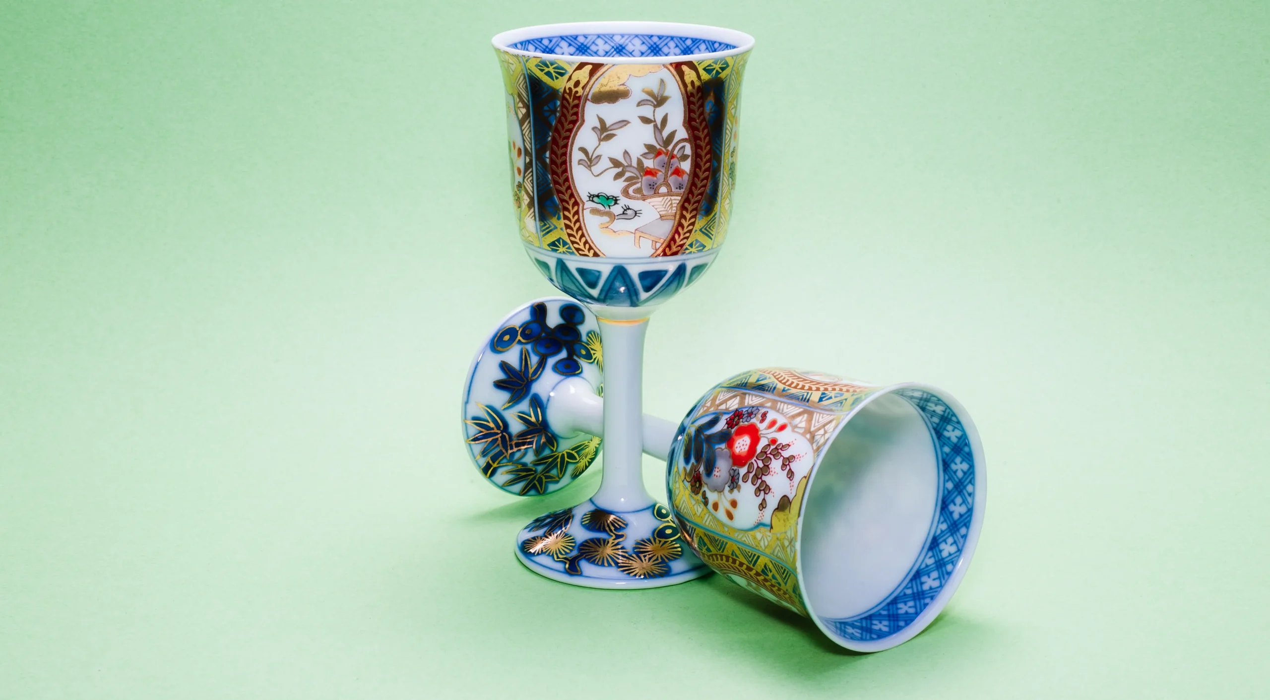 Two intricately designed Kutani-yaki wine glasses