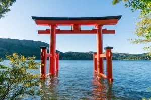 Iconic red torii gate of Hakone Shrine standing on Lake Ashi