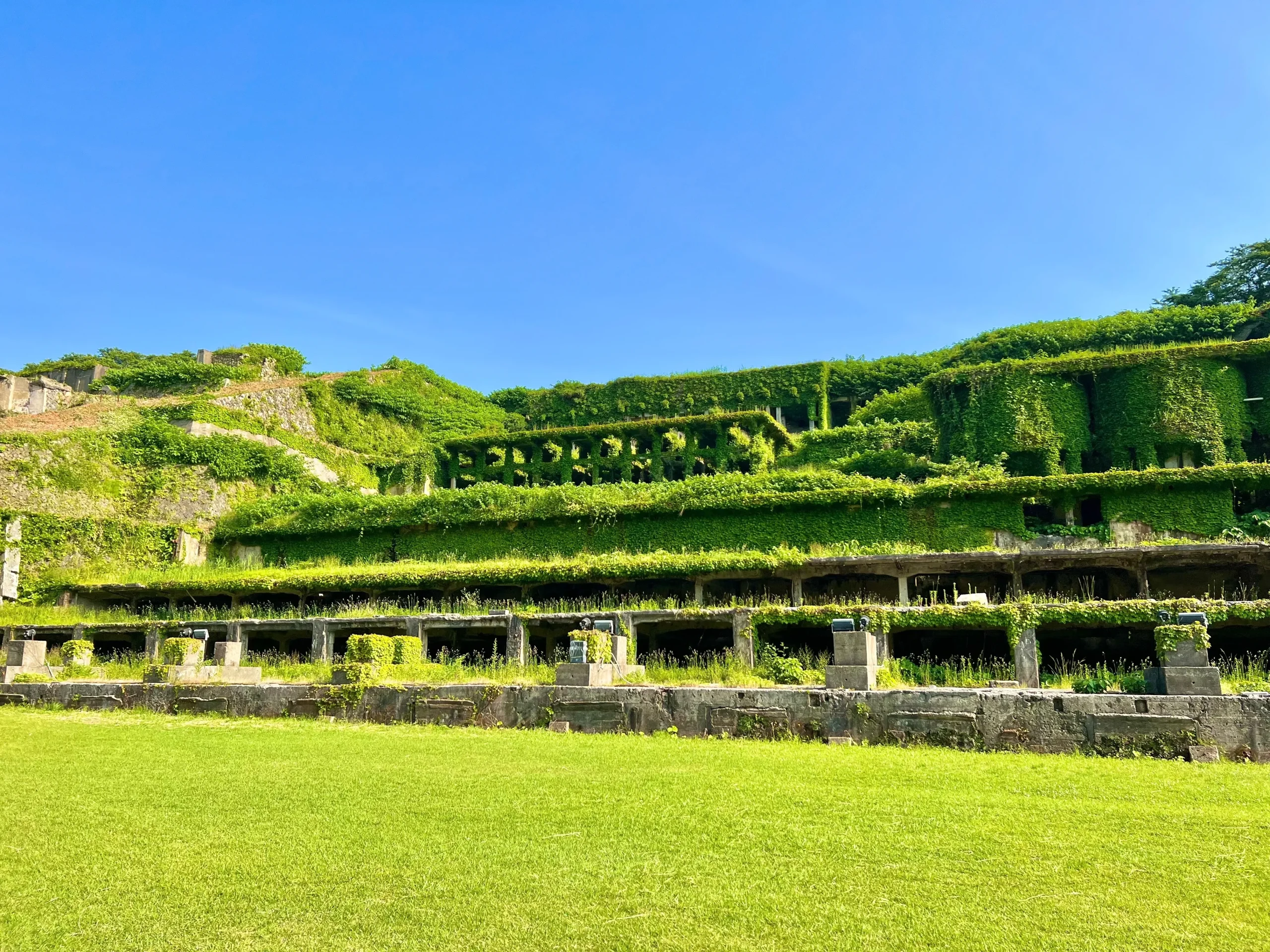 Ruins of Sado Island gold mine covered in green vegetation, Japan