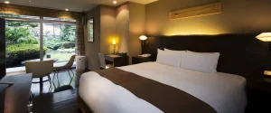 Garden-view room at Sapporo Grand Hotel with king bed and warm lighting for a cozy stay.