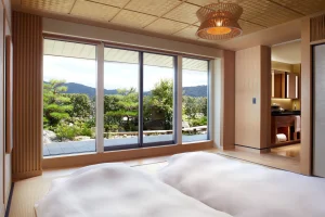 Luxurious guest room at The Ritz-Carlton Kyoto with private garden view and modern tatami design.