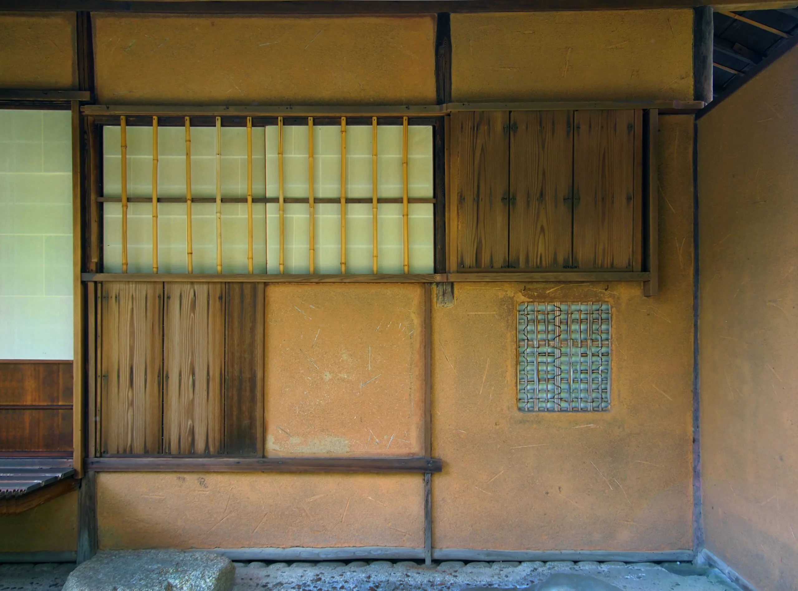 Interior of a traditional Japanese tea room with wooden and clay walls