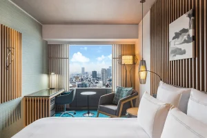 Modern Swissôtel Nankai Osaka room with city view and warm wooden design