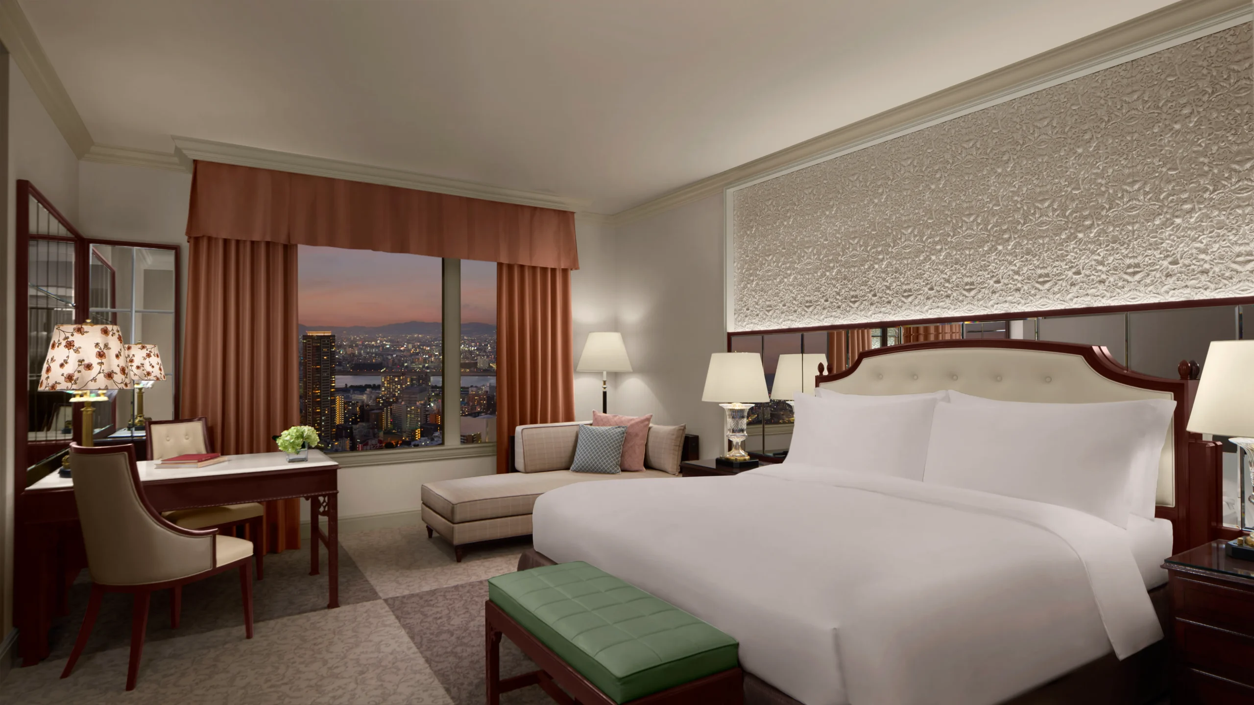 Elegant Ritz-Carlton Osaka suite with classical decor and sunset city view