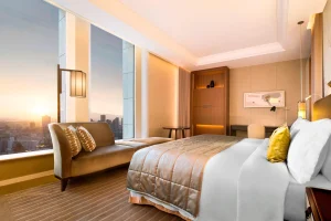 Luxury suite at St. Regis Osaka with panoramic sunset skyline and modern design