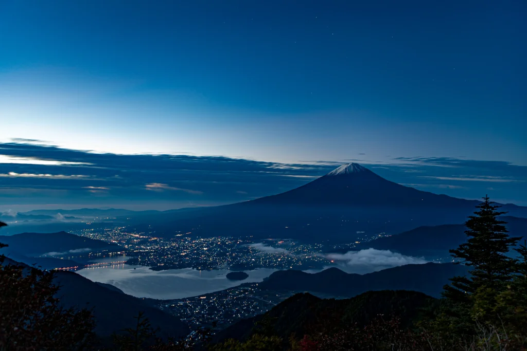 Night view of Mount Fuji and Lake Kawaguchi from Mount Tenjo in Yamanashi, Japan