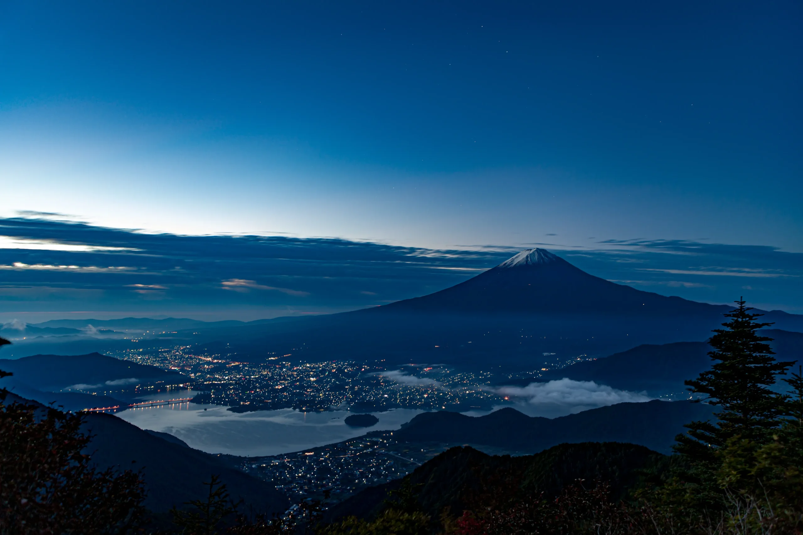 Night view of Mount Fuji and Lake Kawaguchi from Mount Tenjo in Yamanashi, Japan