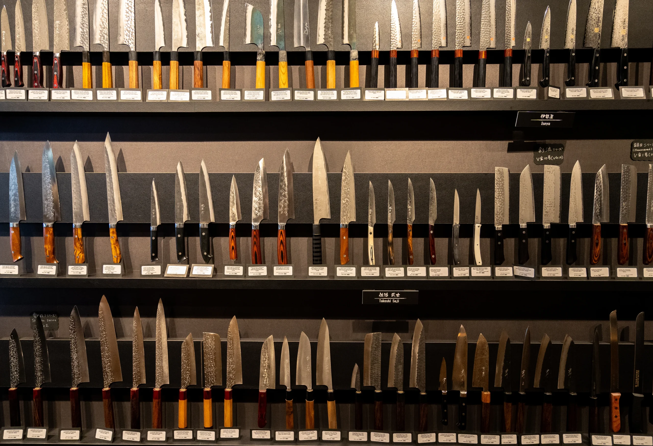 Wide selection of professional Japanese chef knives on display at a Tokyo knife store.