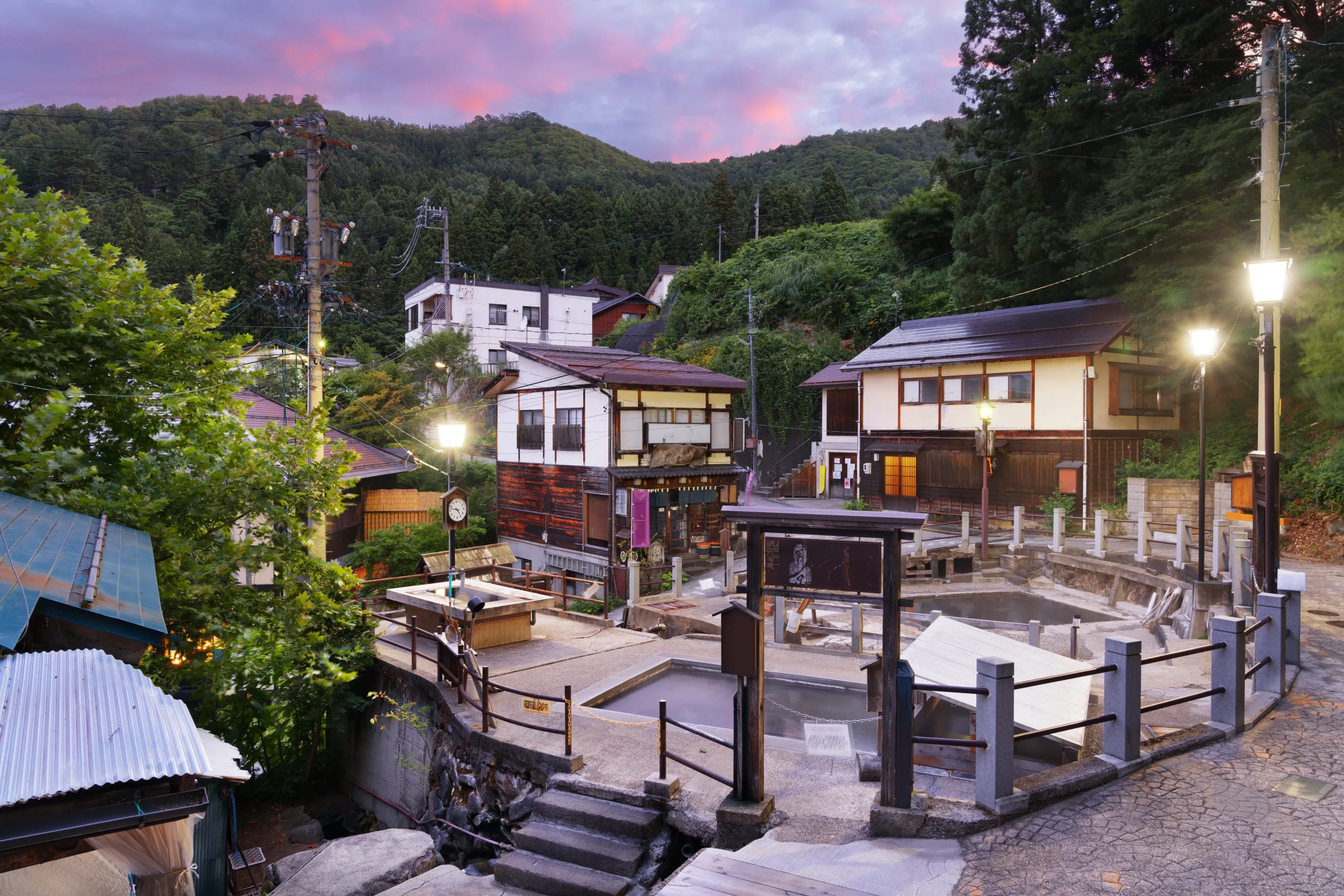 Evening view of Nozawa Onsen village with traditional public bath houses.