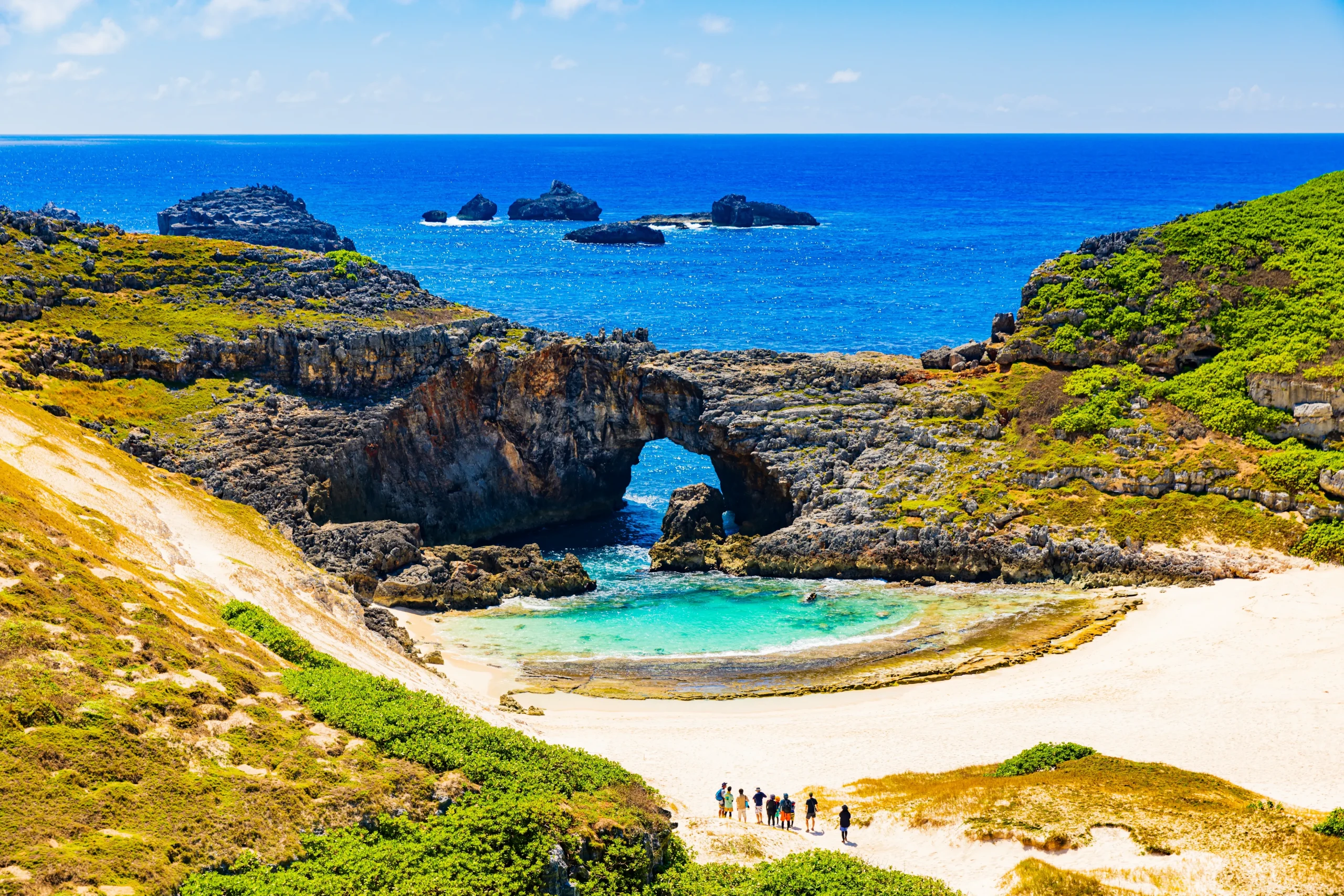 Crystal clear Minamijima beach and natural rock arch in the Ogasawara Islands.