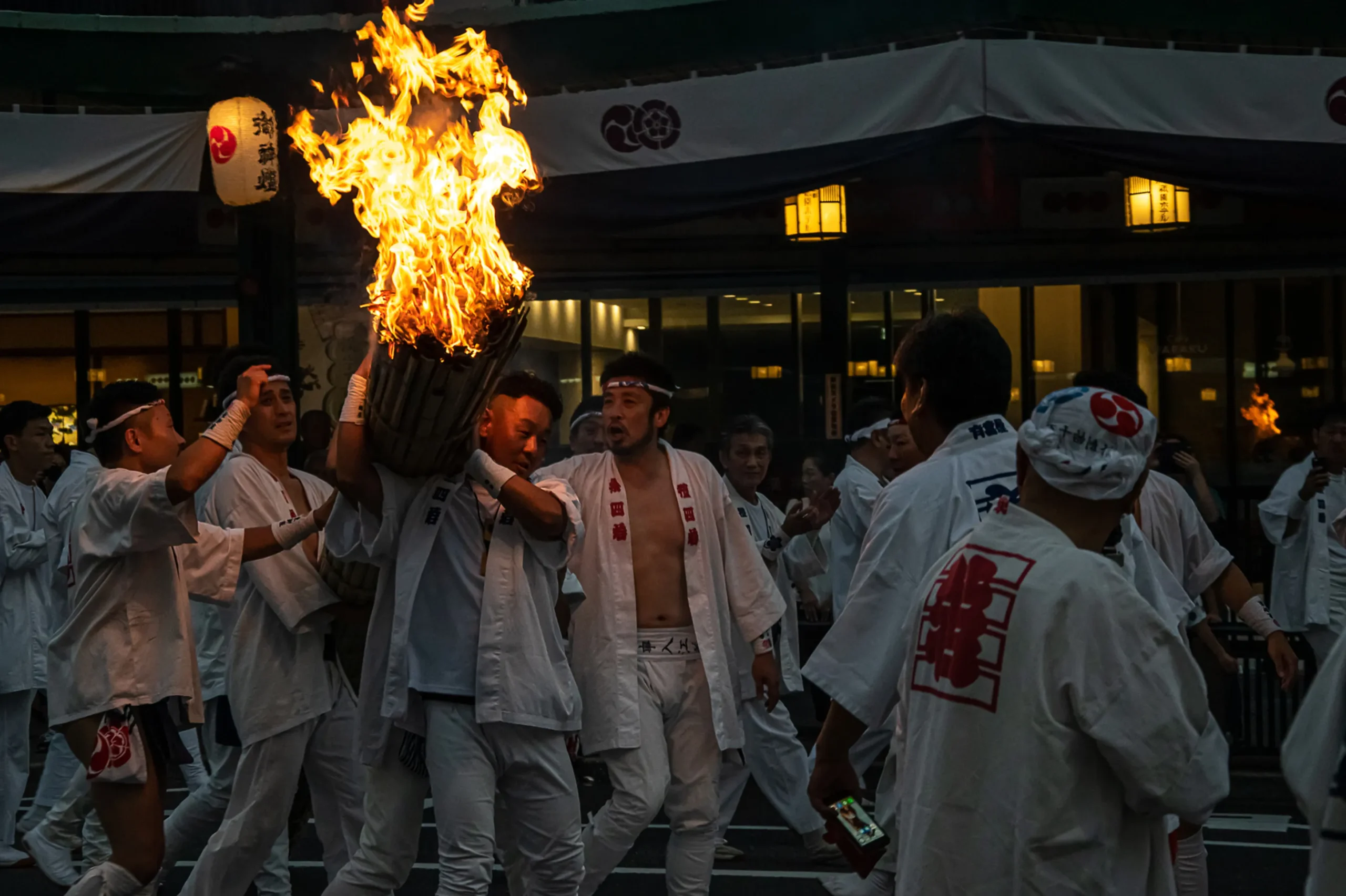 Traditional fire festival participants carrying a torch during Gozan no Okuribi.
