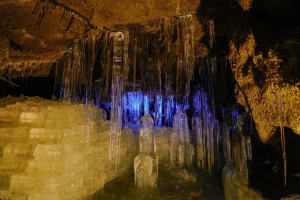 Illuminated ice pillars and icicles inside the Narusawa Ice Cave in Yamanashi.