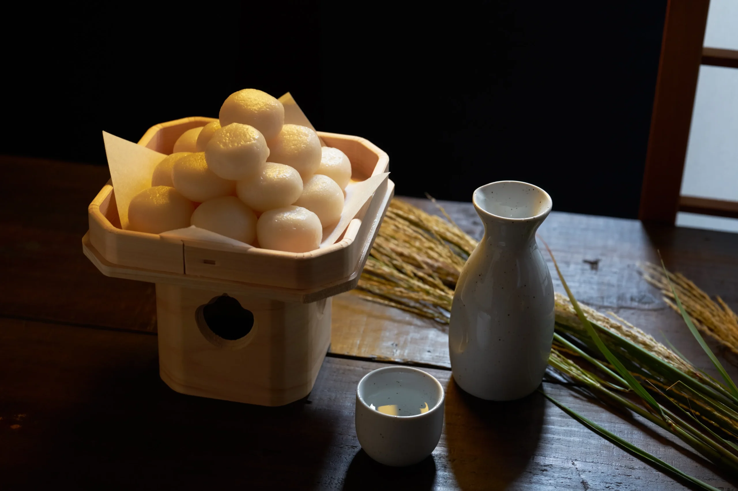 Tsukimi moon viewing with dango rice dumplings and sake on wooden table