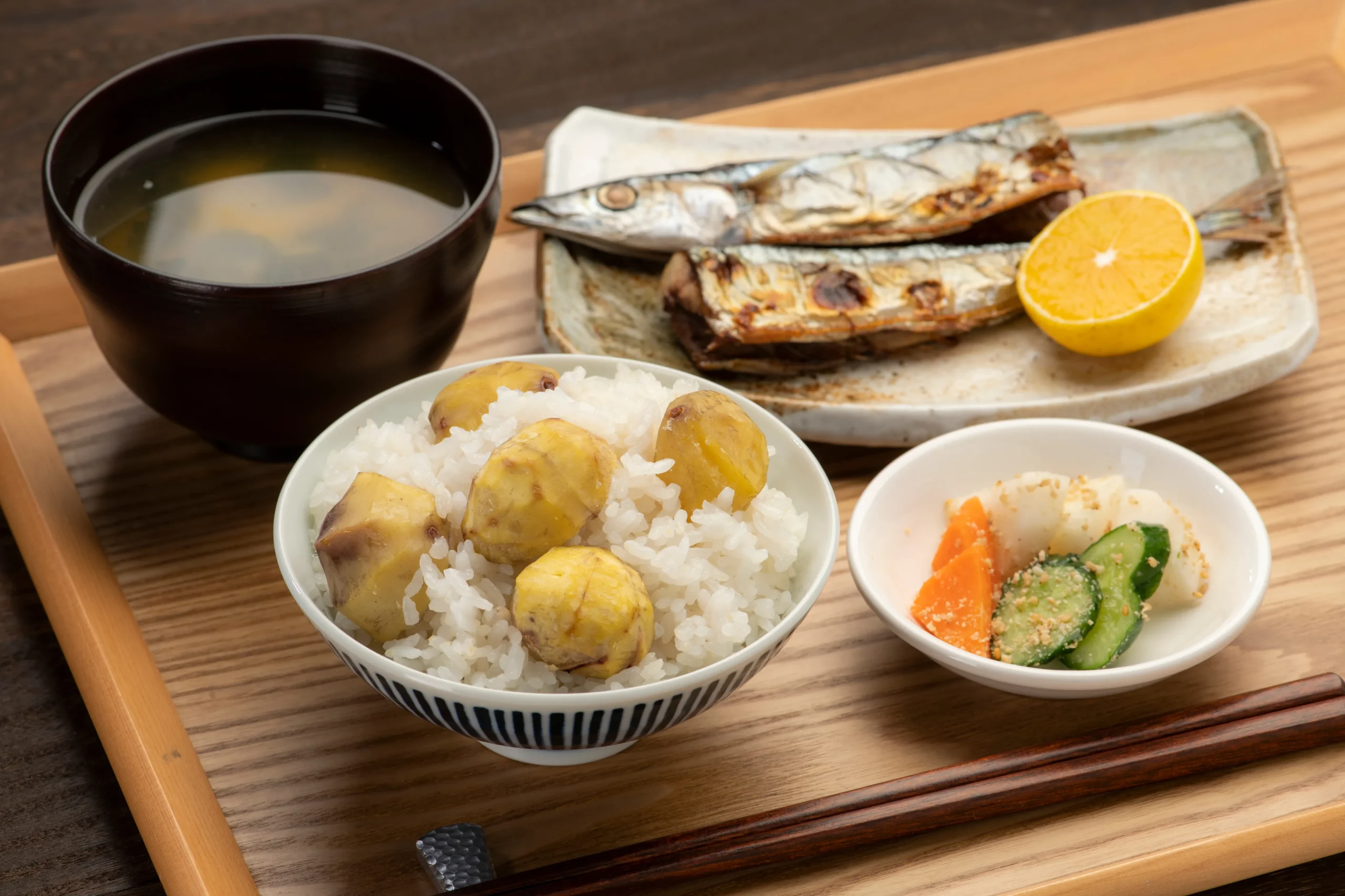 Japanese meal with grilled fish, chestnut rice, miso soup and pickled vegetables
