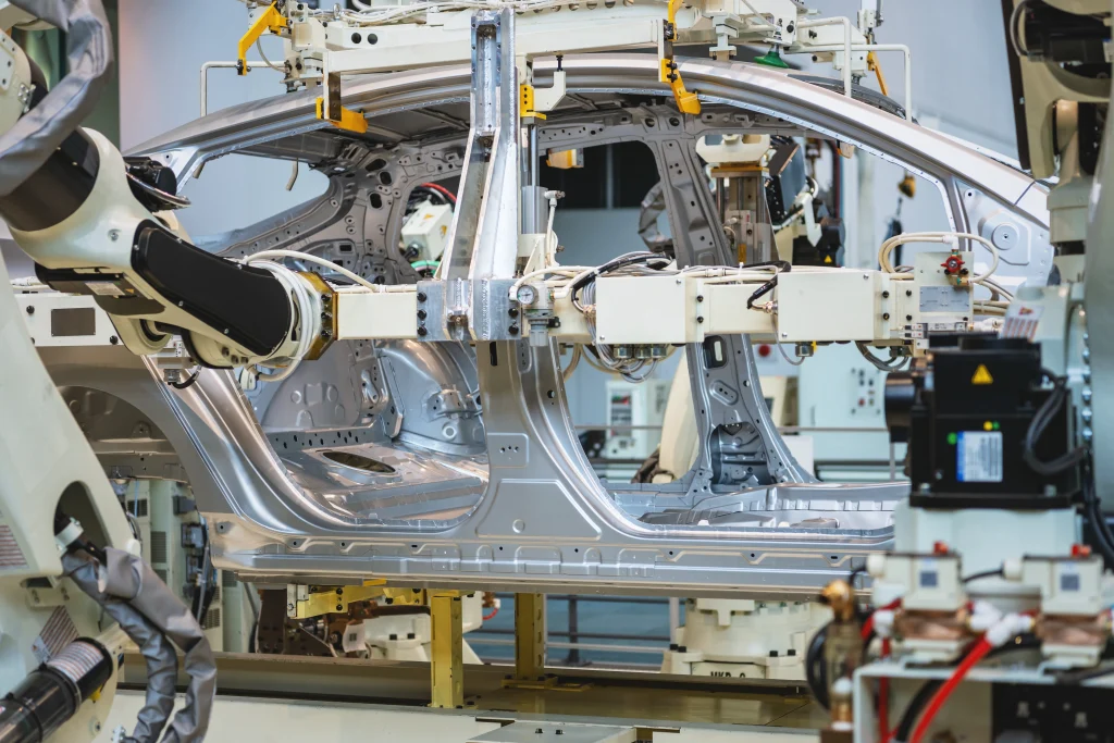 Automotive manufacturing line in Japan with robotic arms assembling car body frame