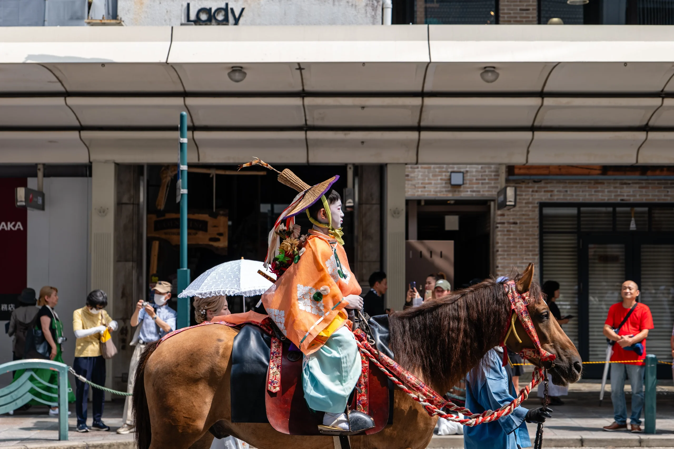 Young chigo participant in ceremonial costume riding horseback during the Gion Matsuri procession