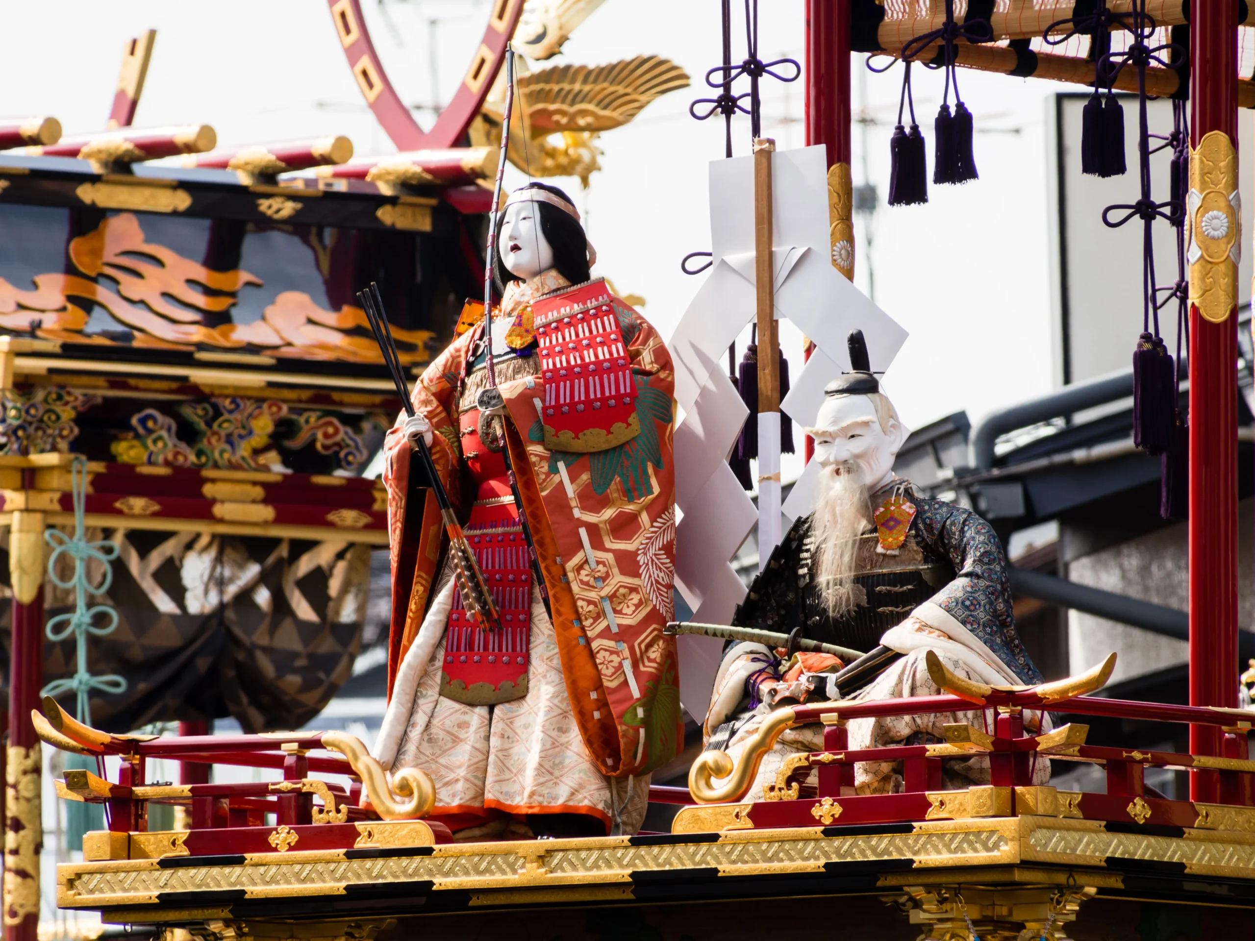 Traditional mechanical dolls (karakuri) displayed on a Takayama Autumn Festival float with detailed samurai costumes and gold decorations