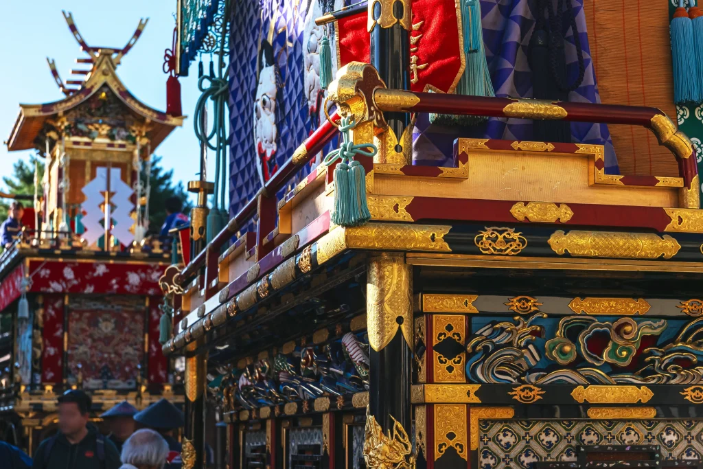 Close-up view of ornate Takayama Autumn Festival floats featuring intricate gold carvings, lacquerwork, and traditional craftsmanship