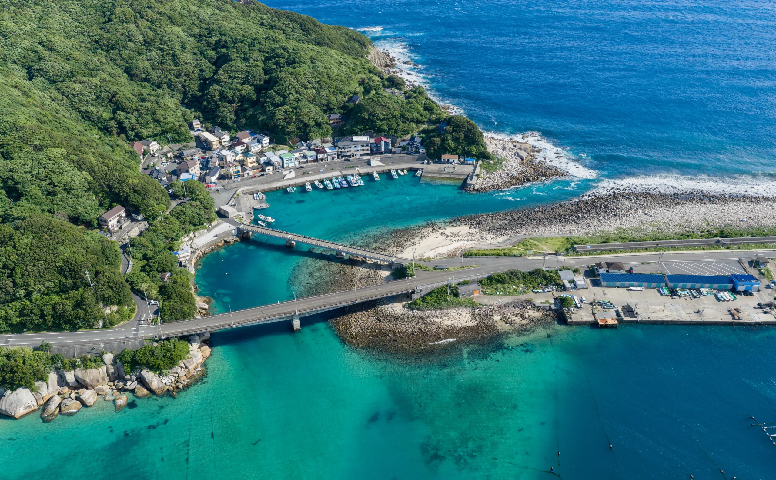 Aerial view of Kashiwajima Island with clear turquoise water and a fishing village, Kochi