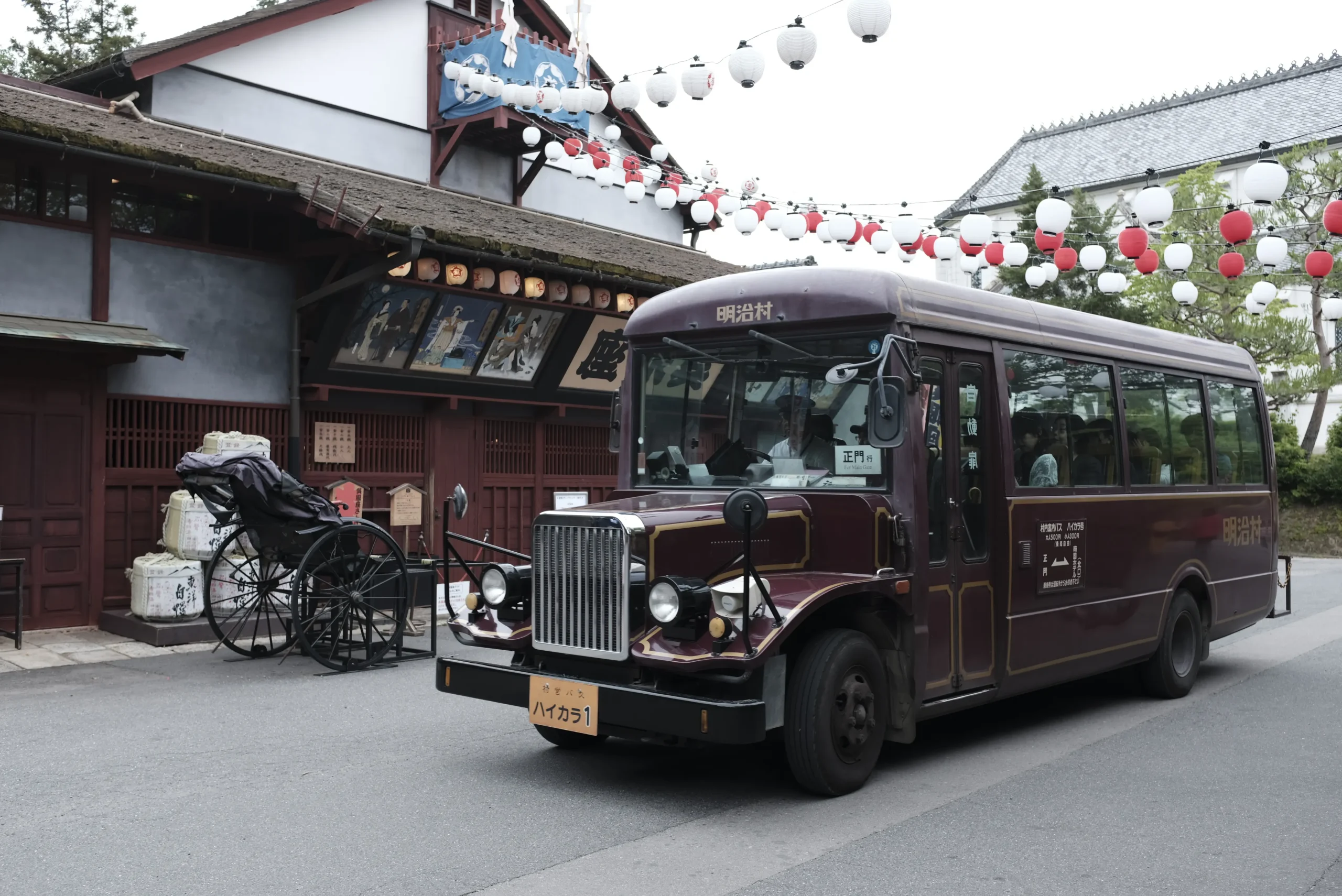 Retro bus and rickshaw in front of a historic theater at Meiji-Mura open-air museum