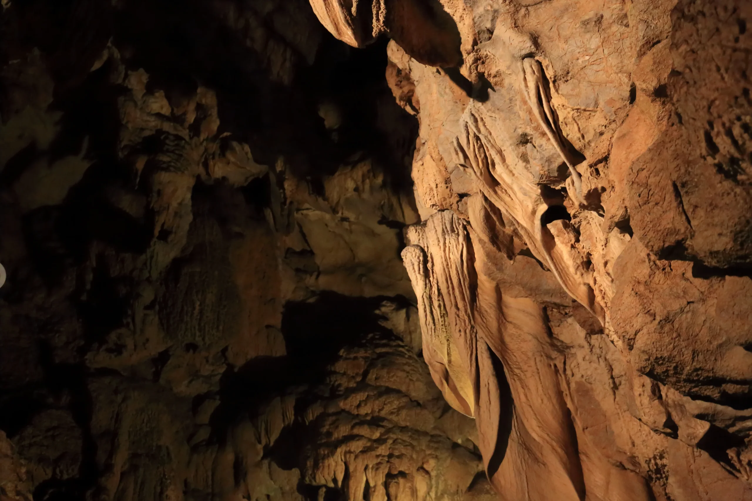 Illuminated limestone formations inside Ryugado Cave in Kochi