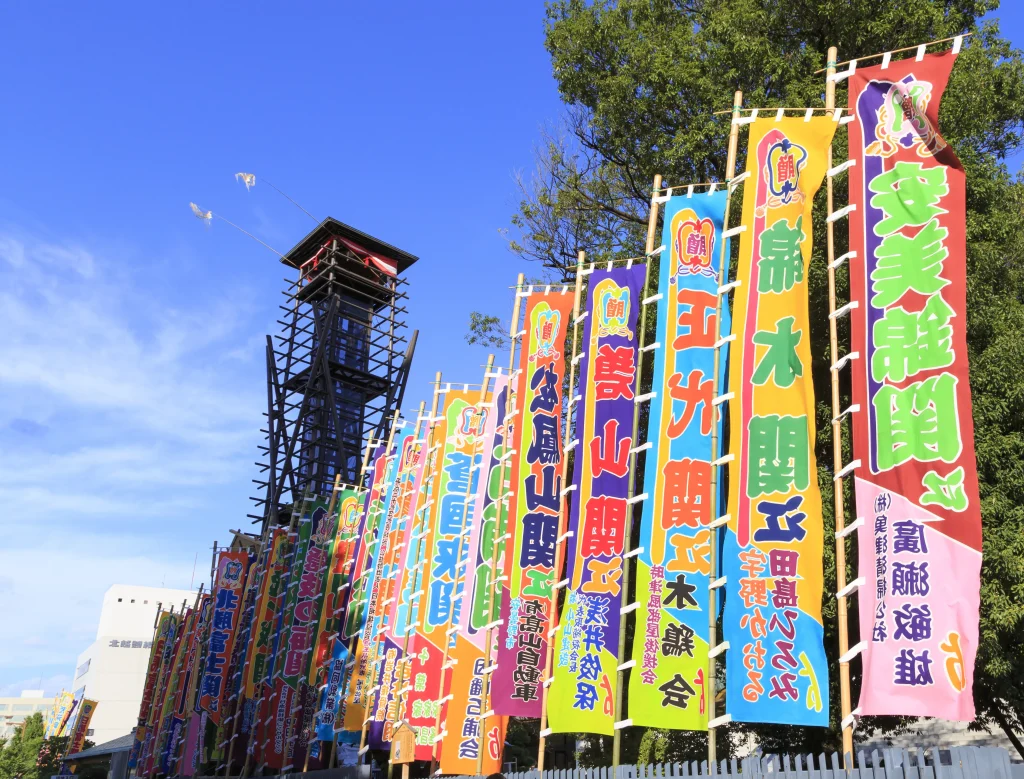 Colorful sumo banners and the yagura drum tower outside Ryogoku Kokugikan in Tokyo