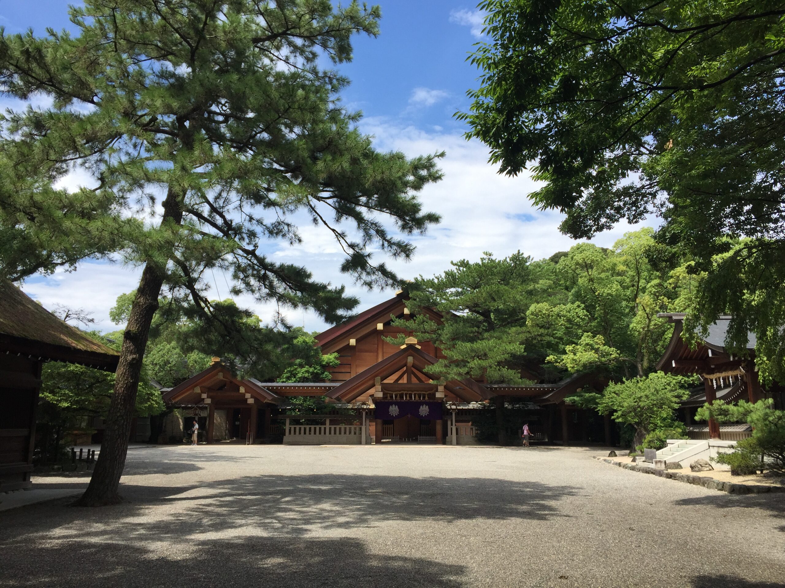 Wooden shrine buildings among green trees at Atsuta Jingu in Nagoya