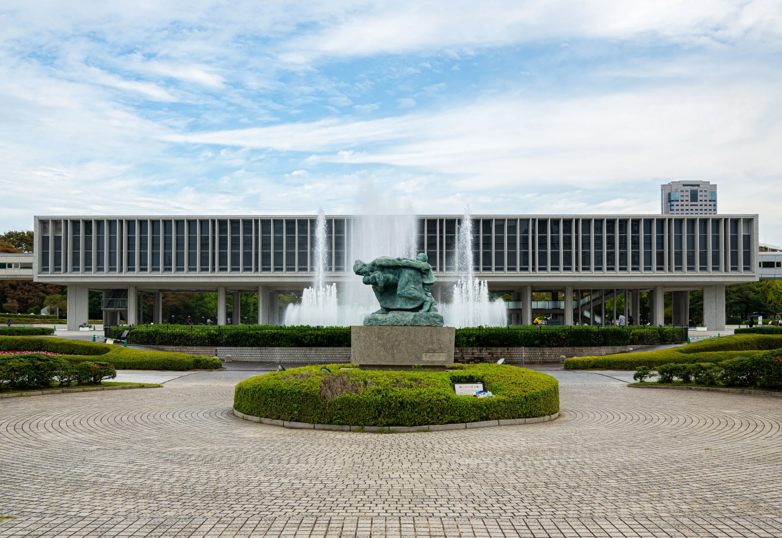 Hiroshima Peace Memorial Museum with a fountain and statue in the Peace Memorial Park