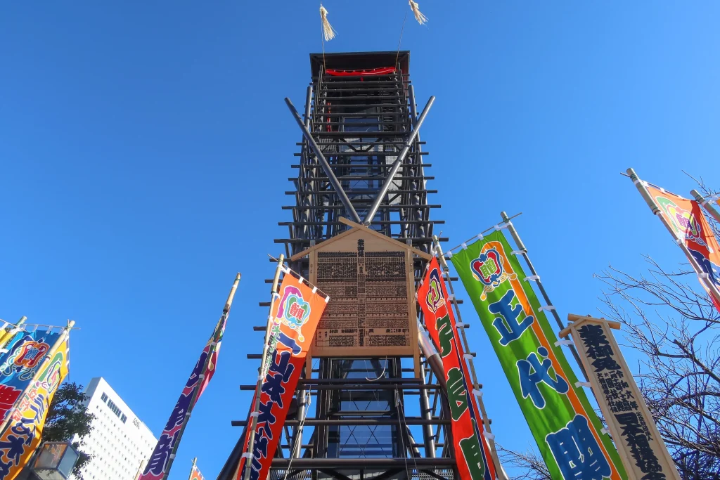 Traditional sumo banners and wooden tower under a clear blue sky in Ryogoku, Tokyo