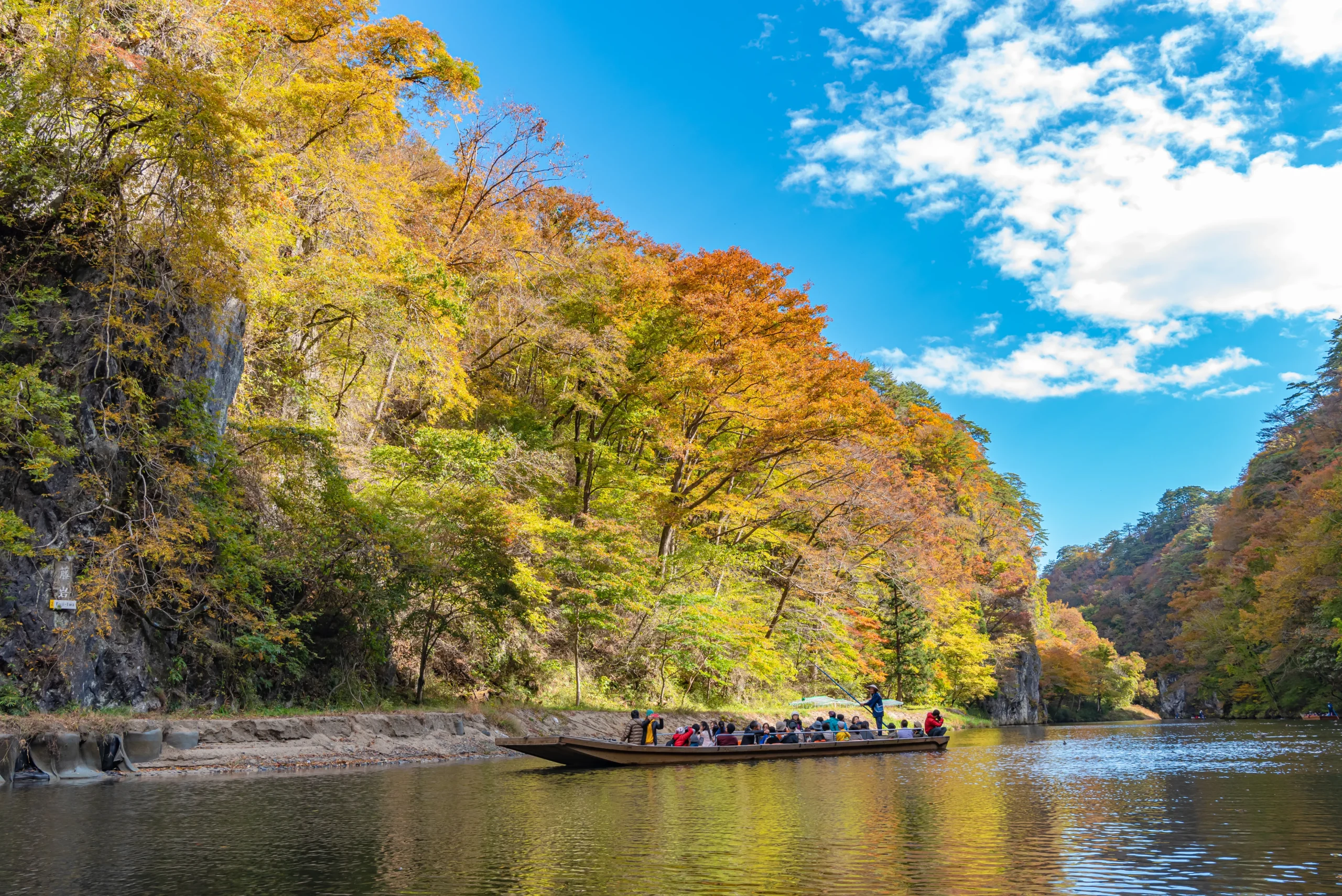 Traditional boat traveling through Geibikei Gorge in Iwate