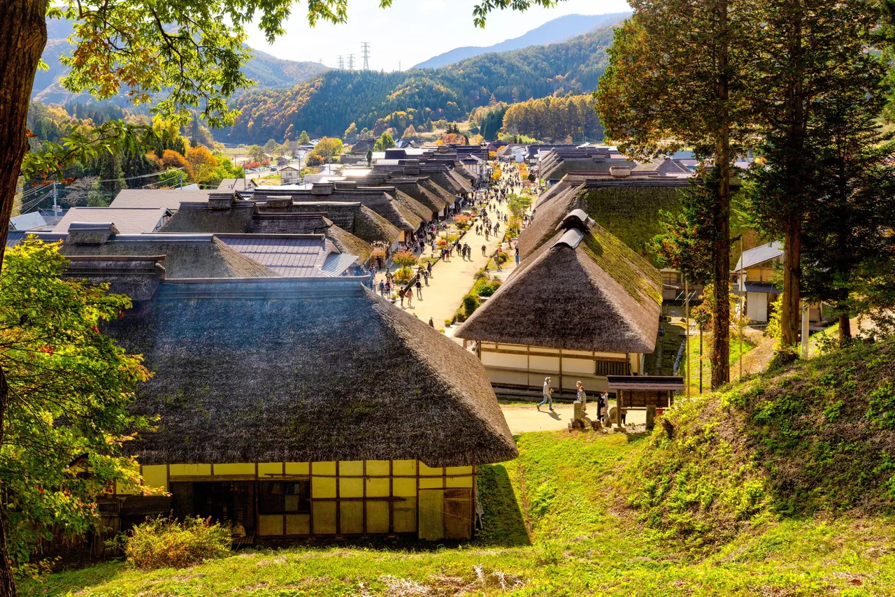 Ouchi-juku post town with rows of thatched-roof houses in autumn, Fukushima