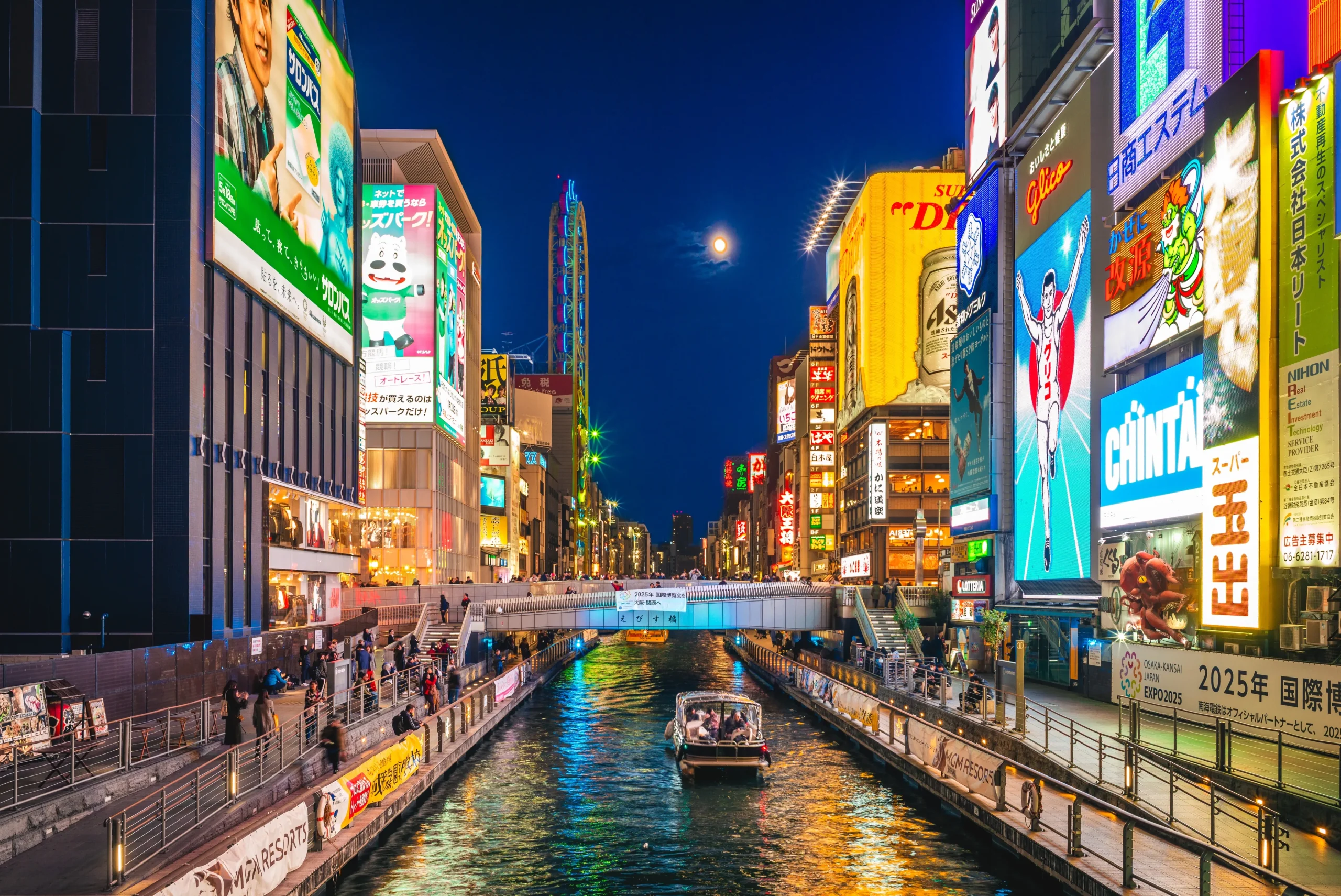 Tombori River Cruise passing through Dotonbori at night in Osaka