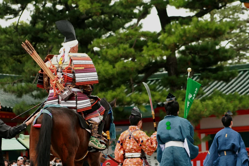 A participant in warrior dress within the grounds of Heian Jingu Shrine during Jidai Matsuri