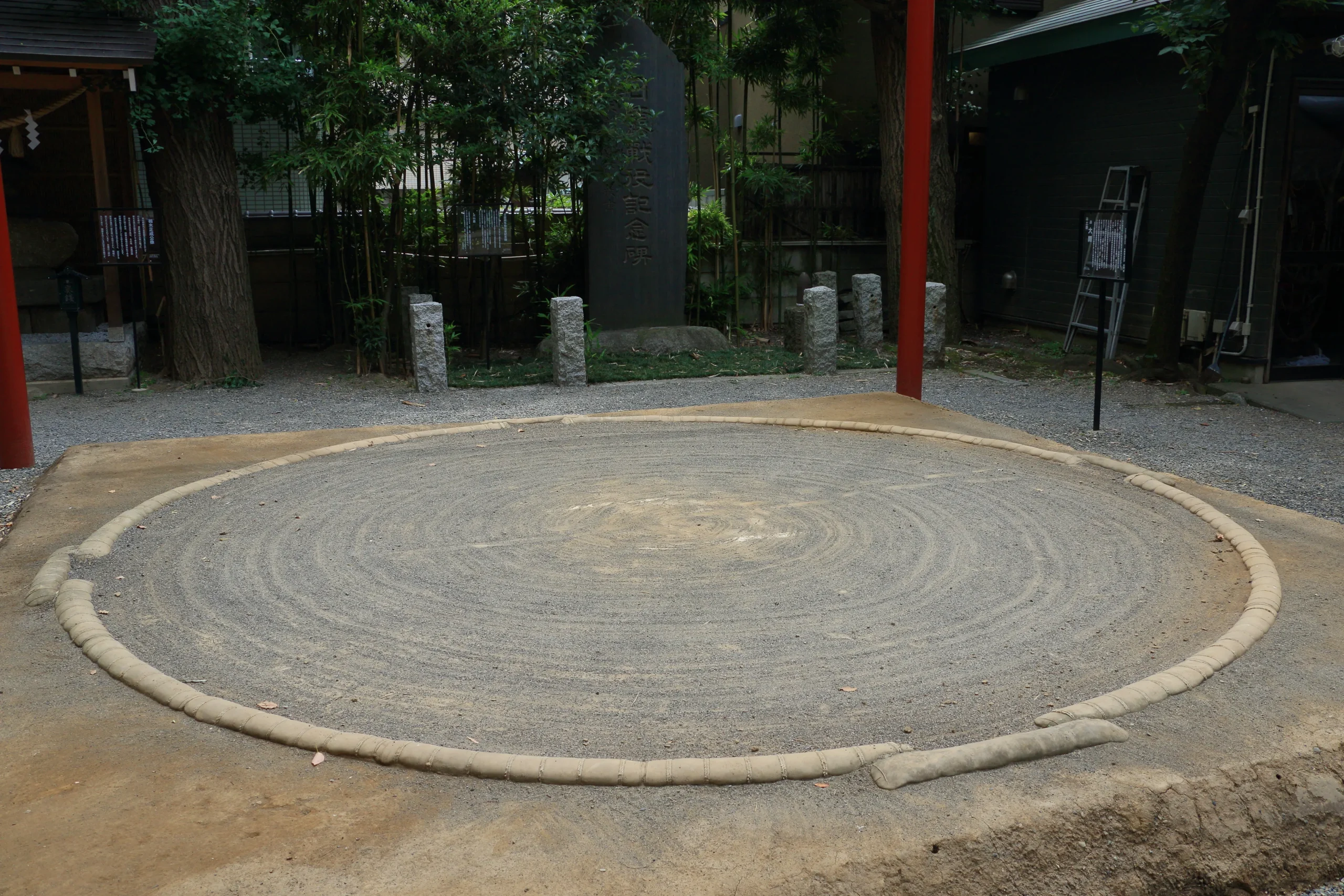 A quiet sumo ring at a Japanese shrine, with no wrestlers present.