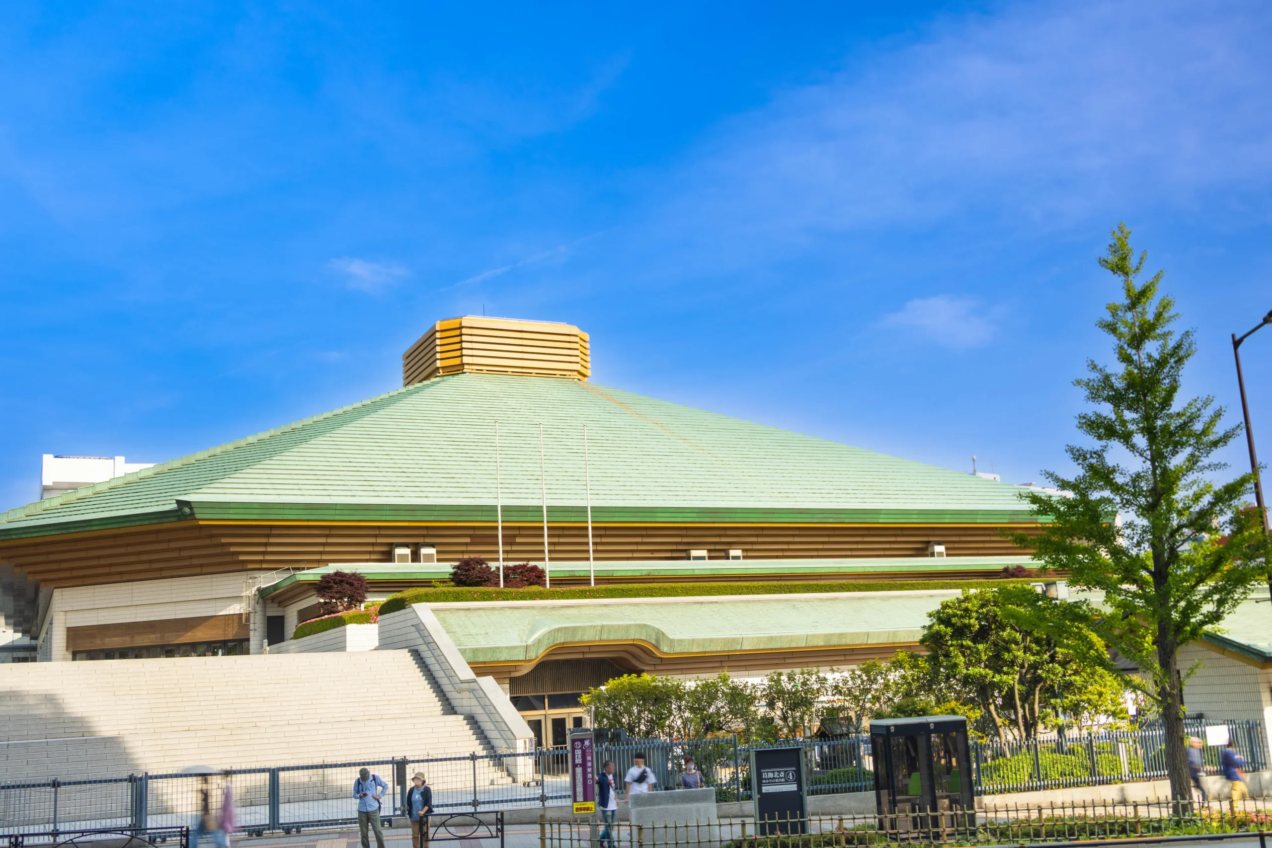 Exterior view of Ryogoku Kokugikan in Tokyo on a sunny day.