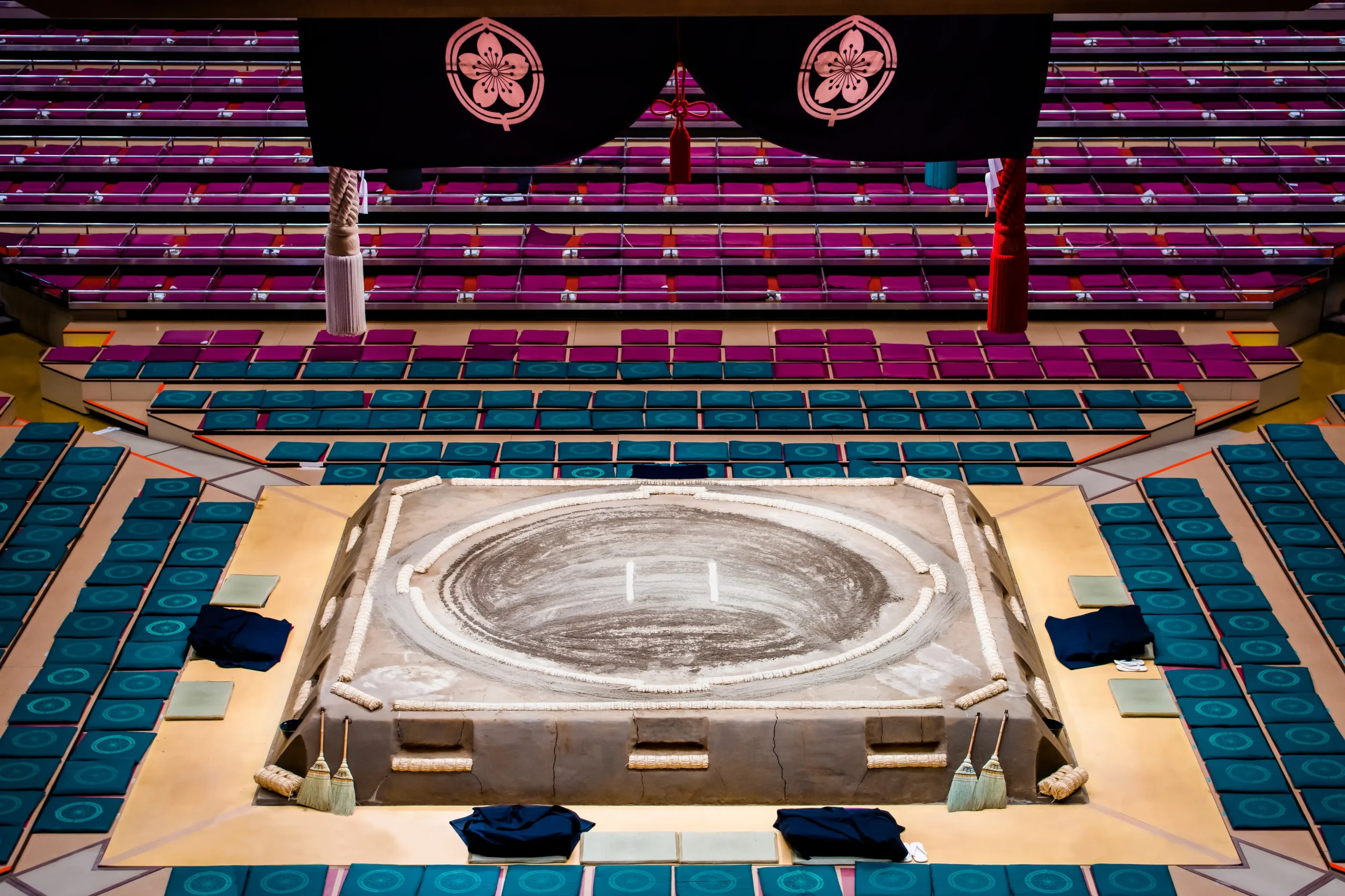 A grand sumo ring beneath a suspended roof