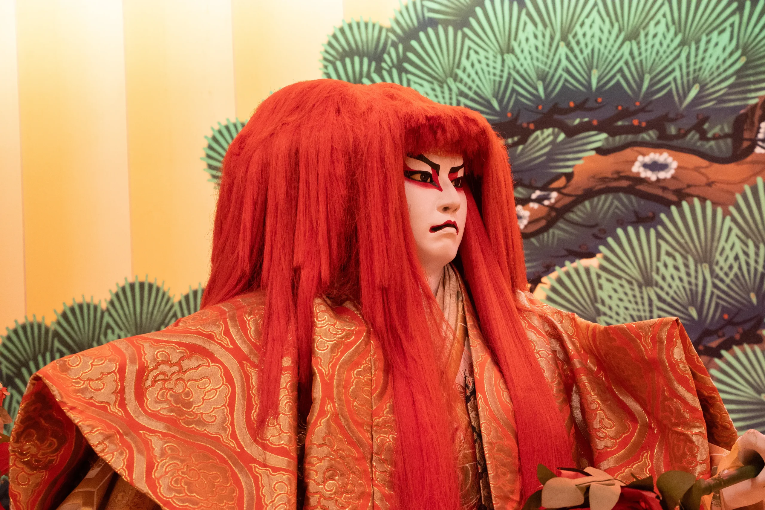 A kabuki doll with red hair.