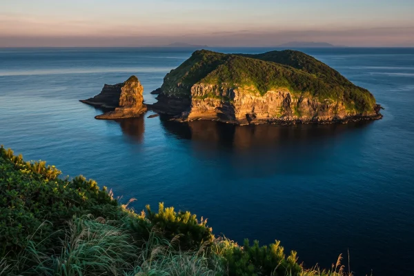 Panoramic view of the volcanic cliffs and sea at Aogashima Island in Tokyo.